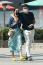<p>Henry Golding and wife Liv Lo cozy up for a stroll around Santa Monica on Thursday. </p>