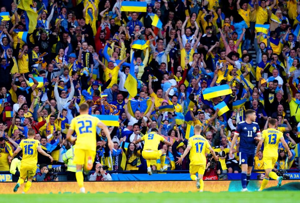 Roman Yaremchuk (centre) celebrates in front of the Ukraine fans after doubling their lead (Jane Barlow/PA) (PA Wire)