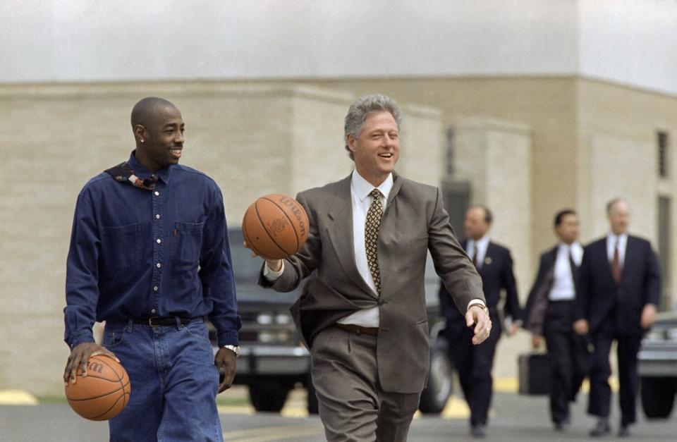 President Bill Clinton walks on the Arkansas State campus with Arthur Agee, a star of the movie "Hoop Dreams."