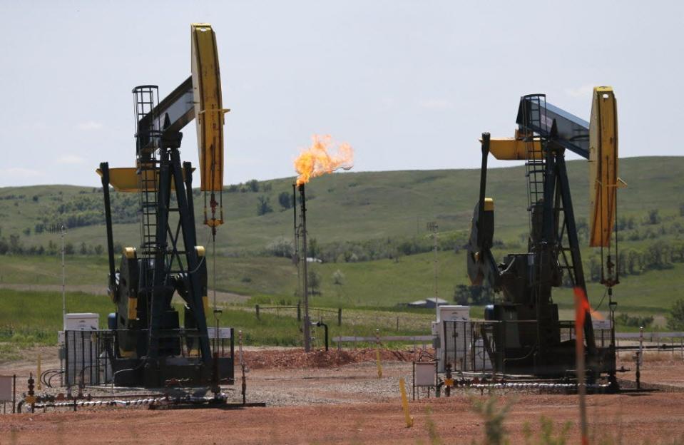 Oil pumps and natural gas burn off in Watford City, N.D.