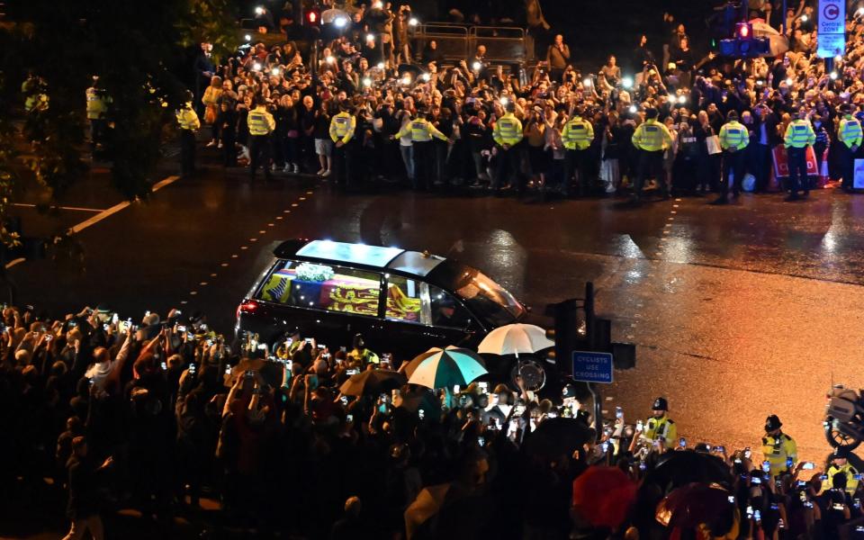 Police hold back crowds as the hearse passes Wellington Arch - Paul Grover for the Telegraph