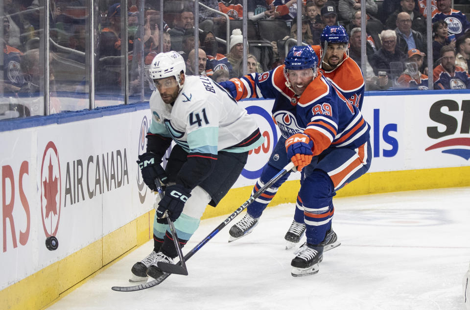 Seattle Kraken's Pierre-Edouard Bellemare (41) and Edmonton Oilers' Sam Gagner (89) battle for the puck during the second period of an NHL hockey game, Wednesday, Nov. 15, 2023 in Edmonton, Alberta. (Jason Franson/The Canadian Press via AP)