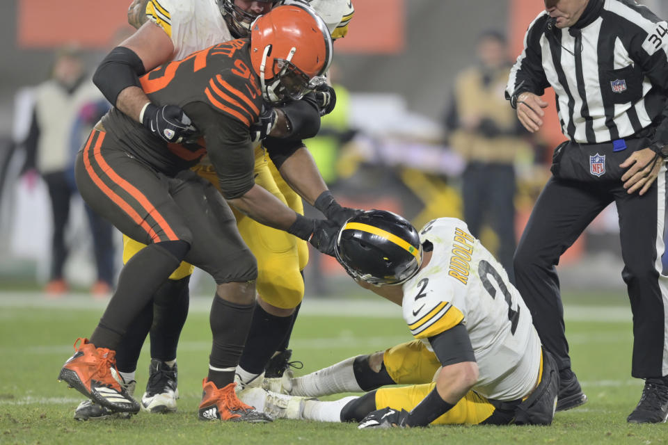 Cleveland Browns defensive end Myles Garrett (95) pulls the helmet off Pittsburgh Steelers quarterback Mason Rudolph (2) in the fourth quarter of an NFL football game, Thursday, Nov. 14, 2019, in Cleveland. The Browns won 21-7. (AP Photo/David Richard)