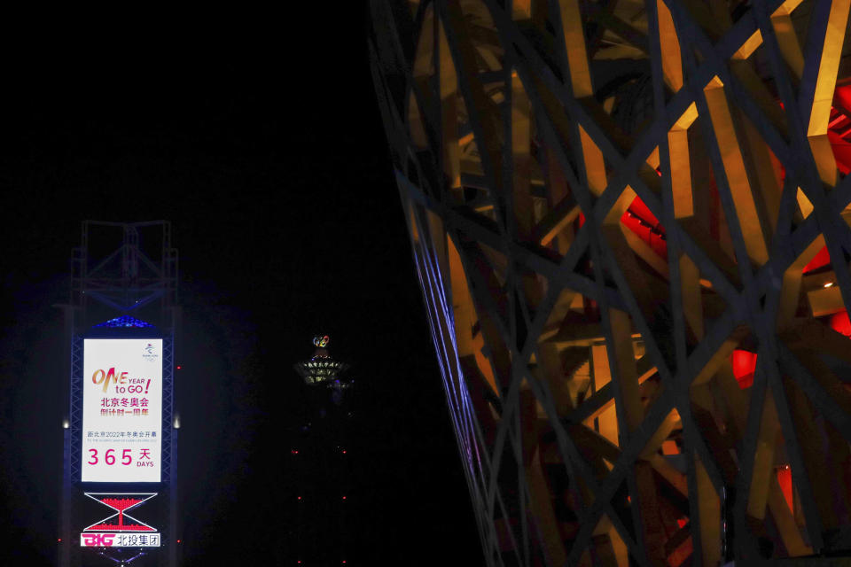 FILE - In this Feb. 3, 2021, file photo, a countdown clock showing one year to go for the 2022 Beijing Olympics stands near the Olympics Tower, rear center, and National Stadium, also known as the Bird's Nest, which will again be a venue for the Olympics, in Beijing. Some expect North Korea to emerge again from its self-imposed lock-down next year when China, the North’s only major ally and a key political and aid lifeline, hosts the Winter Games. (AP Photo/Andy Wong, File)