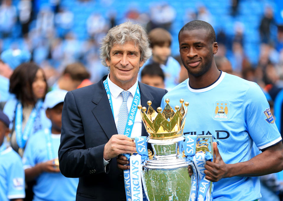 Manchester City's manager Manuel Pellegrini (left) and Yaya Toure celebrates with the trophy