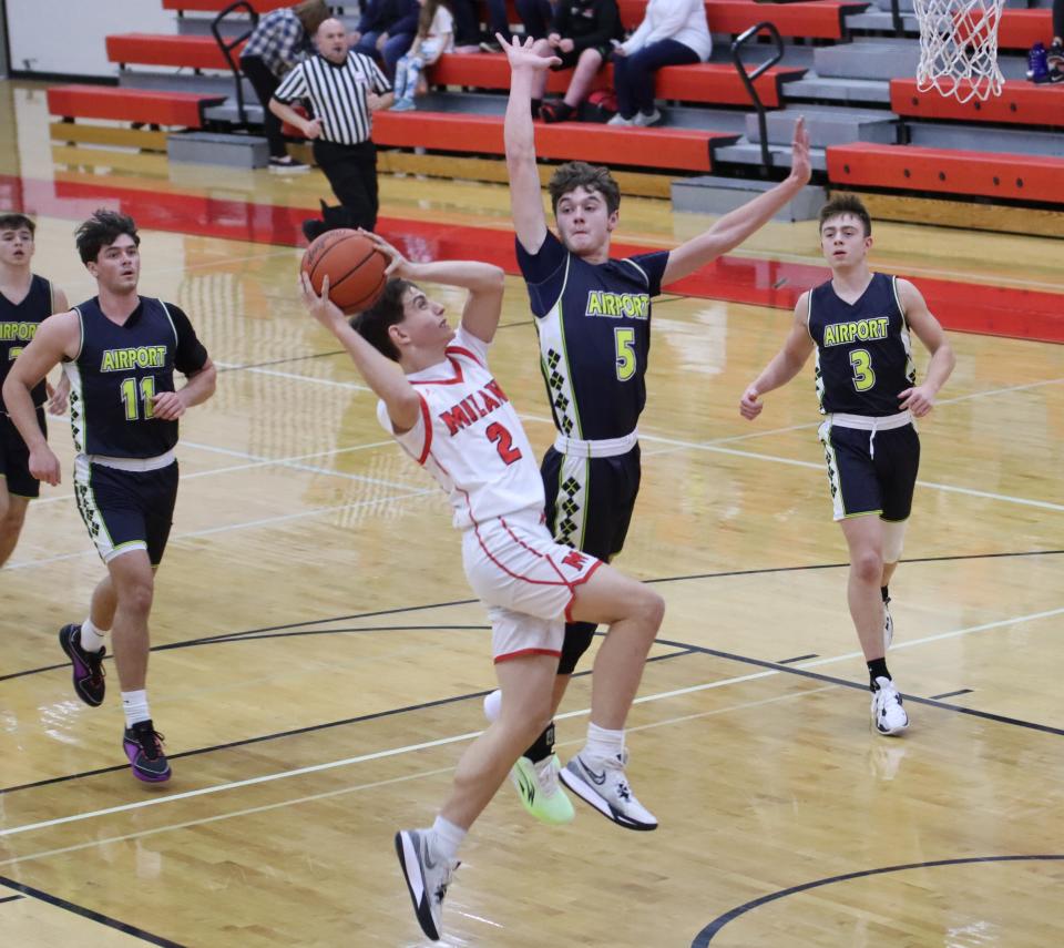 Dillon Byrd of Airport challenges a shot by Milan's Gavin Mick during a 76-36 Airport win Tuesday night.