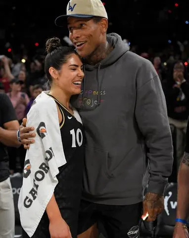 <p>David Becker/NBAE via Getty</p> NFL player, Darren Waller embraces Kelsey Plum #10 of the Las Vegas Aces after Round 1 Game 1 of the 2022 WNBA Playoffs on August 17, 2022 at Michelob ULTRA Arena in Las Vegas, Nevada.