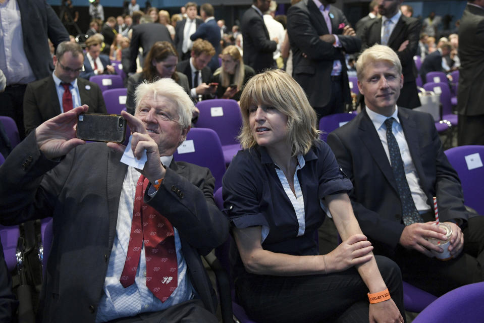 FILE - In this July 23, 2019 file photo, father of Boris Johnson, Stanley Johnson, left, and Boris Johnson's siblings Rachel Johnson and Jo Johnson look on after Johnson was announced as Prime Minister, in London. British Prime Minister Boris Johnson’s bad week got even worse Thursday, Sept. 5 when younger brother Jo Johnson walked away from his government post to protest his big brother’s Brexit policy. (Stefan Rousseau/Pool Photo via AP, file)