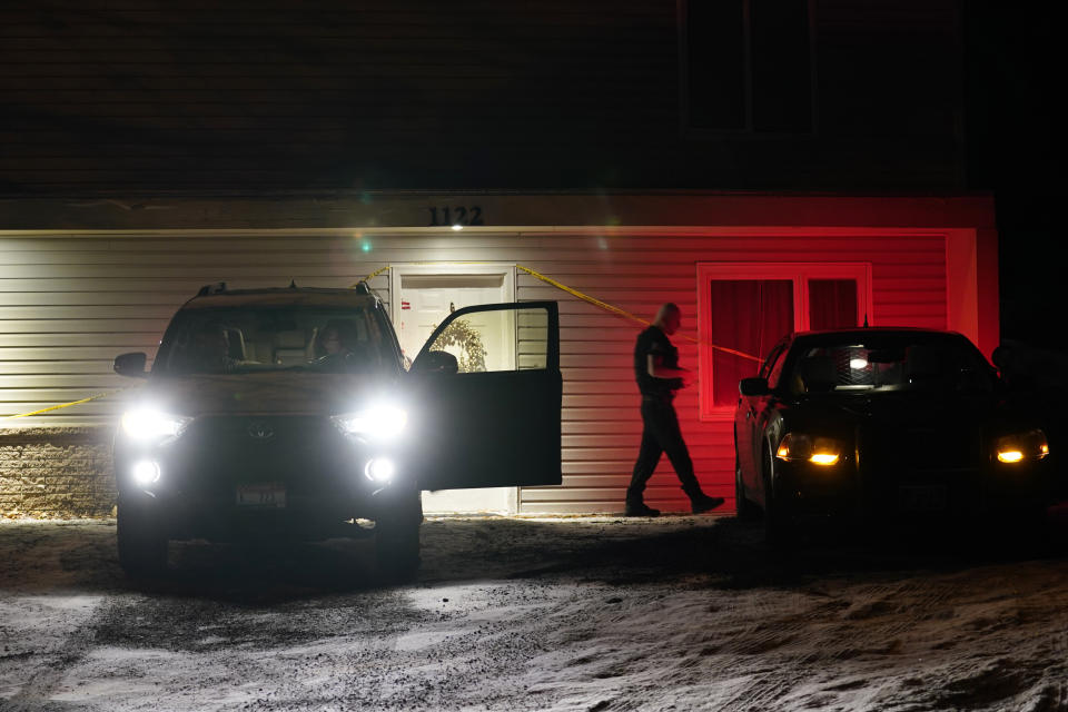 A private security officer, right, walks to his car after talking the occupants of another vehicle at left, Tuesday, Jan. 3, 2023, in front of the house in Moscow, Idaho where four University of Idaho students were killed in November, 2022. Authorities said Wednesday, Jan. 4, that Bryan Kohberger, the man accused in the killings, has left a Pennsylvania jail in the custody of state police. The move means Kohberger could be headed to Idaho to face first-degree murder charges. (AP Photo/Ted S. Warren)