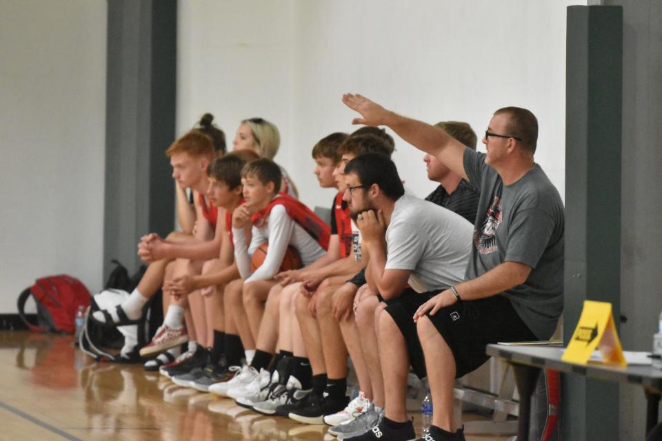 Eastern Greene boys' basketball coach Jamie Hudson orchestrates his team's defensive effort against Shoals in Bloomington Summer League play.