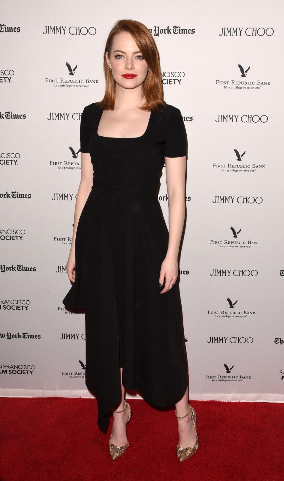 <p>A simply black, boat neck dress was Emma’s pick for an event honouring ‘La La Land’, hosted by the SF Film Society. [Photo: Getty] </p>