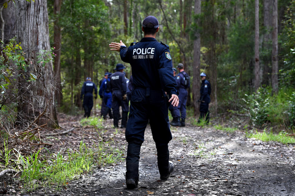 A policeman searches the bush after William's disappearance in 2014.