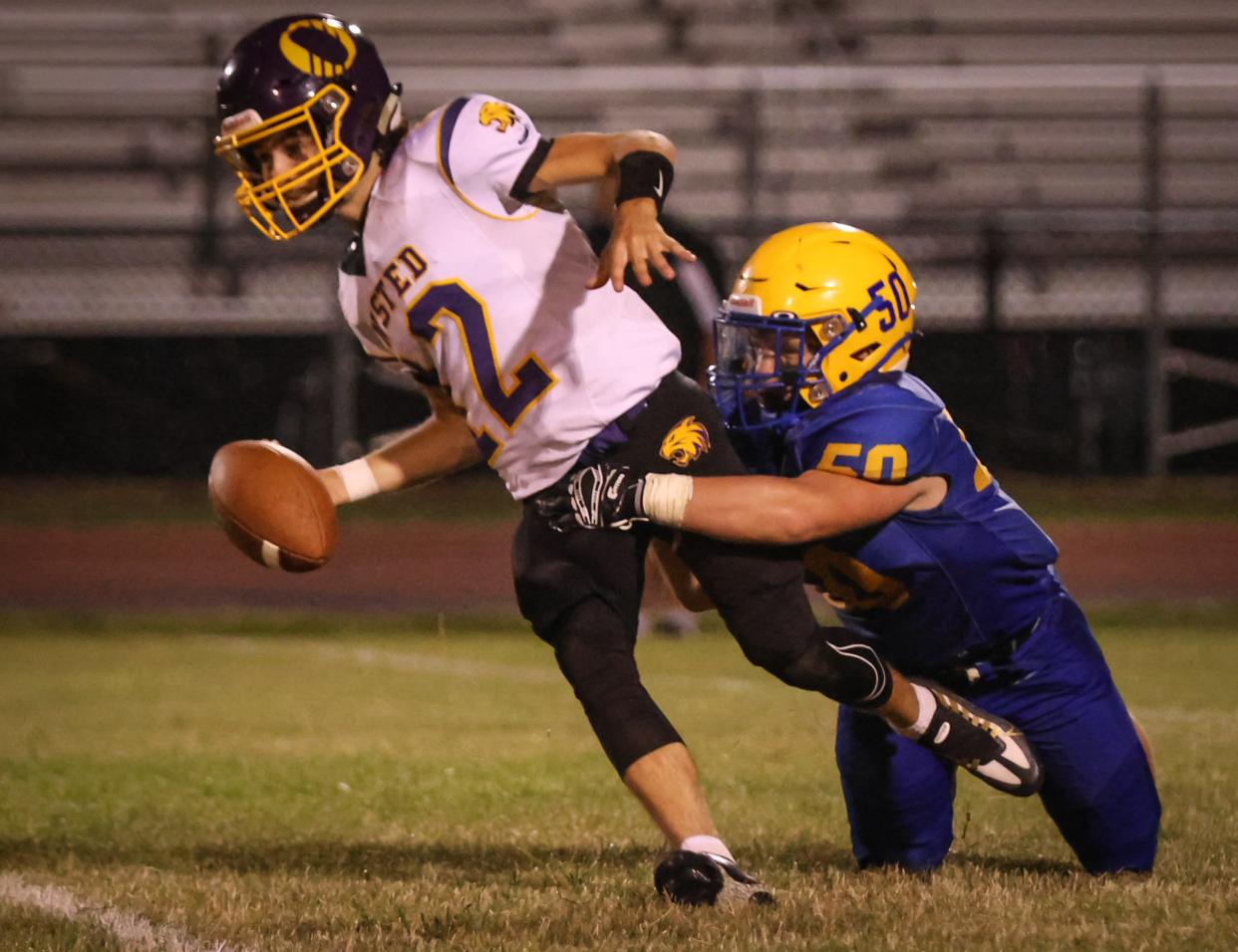 Jefferson's Kameron Woiderski (right) sacks Onsted quarterback Hunter Kelly late in the fourth quarter of a 14-12 Jefferson win Thursday.