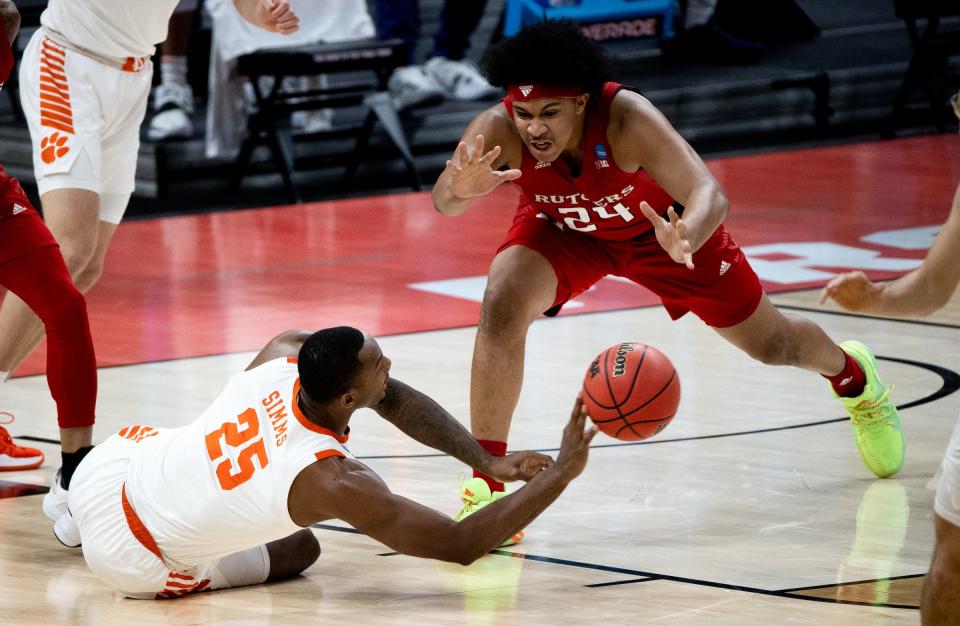 Clemson forward Aamir Simms attempts to throw the ball to a teammate as Rutgers guard Ron Harper Jr. approaches during the first round at Bankers Life Fieldhouse.