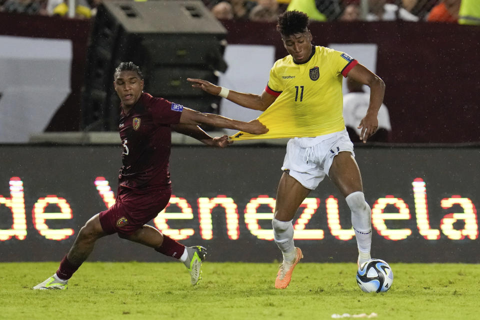 Ecuador's Kevin Rodriguez, right, and Venezuela's Christian Makoun, compete for the ball during a FIFA World Cup 2026 qualifying soccer match at the Monumental de Maturin Stadium in Maturin, Venezuela, Thursday, Nov. 16, 2023. (AP Photo/Ariana Cubillos)