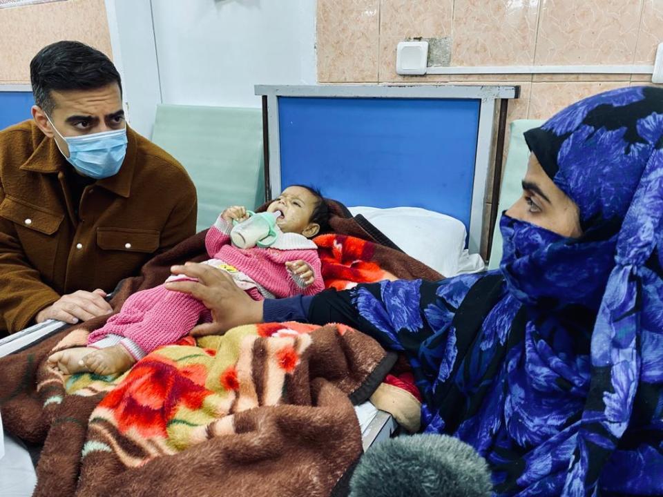 Afghan mother Arezo speaks with CBS News' Imtiaz Tyab as her daughter, 6-month-old Sofia, receives emergency treatment for severe anemia caused by accute malnutrition at the Indira Ghandi Children's Hospital in Kabul, October 18, 2021. / Credit: CBS News