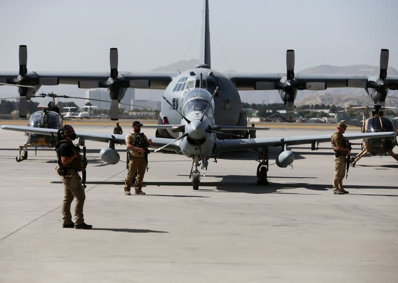 FILE PHOTO: U.S. security personnel stand guard during a handover ceremony of A-29 Super Tucano planes from U.S. to the Afghan forces, in Kabul, Afghanistan