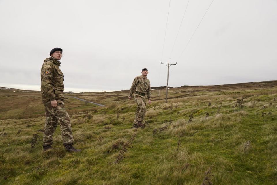 Members of the armed forces check on overhead power cables (Danny Lawson/PA) (PA Wire)