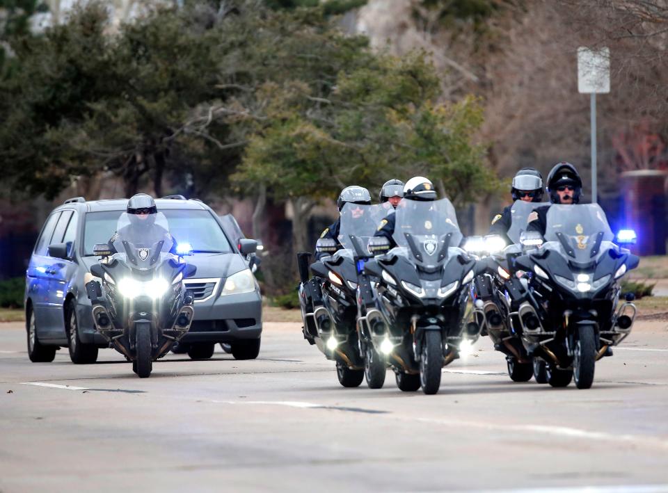 Law enforcement members escort the body of Oklahoma County sheriff's deputy Jeremy McCain on Monday.