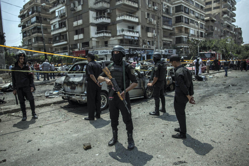 FILE -- In this June 29, 2015 file photo, Egyptian policemen stand guard at the site of a bombing that killed Egypt's top prosecutor, Hisham Barakat, who oversaw cases against thousands of Islamists, in Cairo. On Wednesday, Feb. 20, 2019 Egypt executed nine suspected Muslim Brotherhood members convicted of involvement in the 2015 assassination of Barakat, security officials said. The nine were found guilty of taking part in the bombing that killed Barakat, the first assassination of a senior official in Egypt in a quarter century. (AP Photo/Eman Helal, File)