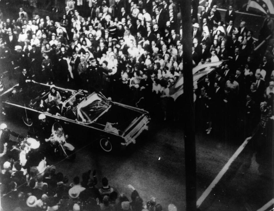 John F Kennedy, 35th president of the US, and first lady Jacqueline Kennedy traveling in the presidential motorcade in Dallas, shortly before his assassination (Keystone/Getty)