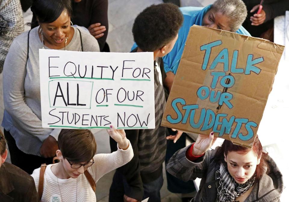 People standing with posters in a crowd