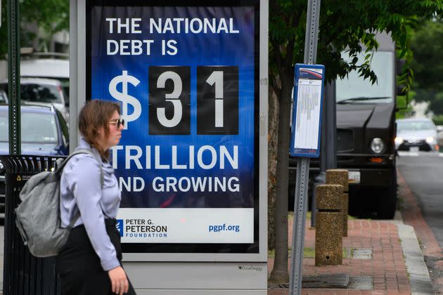 A poster on a Washington, D.C., bus shelter shows the national debt as of Friday.