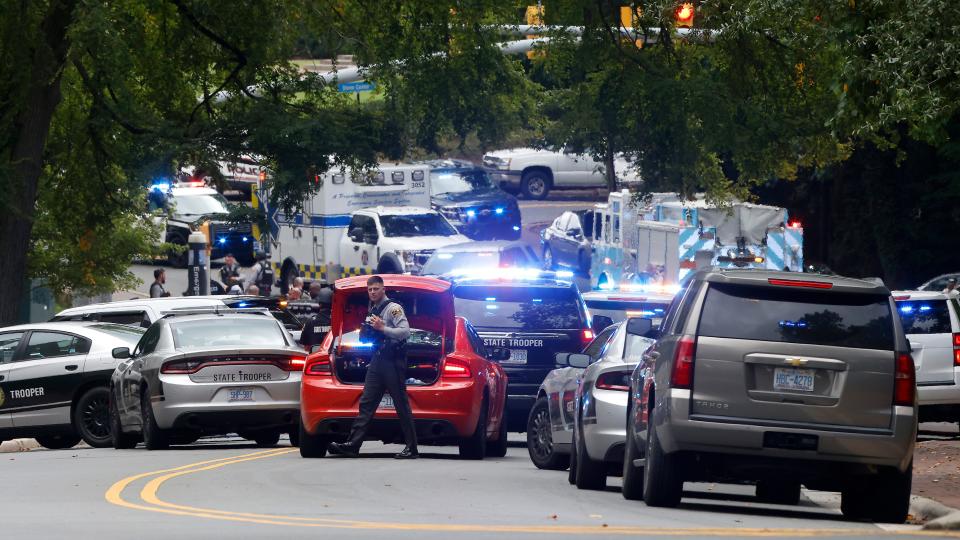 Law enforcement and first responders gather on South Street near the Bell Tower on the University of North Carolina at Chapel Hill campus in Chapel Hill, N.C., Monday, Aug. 28, 2023, after a report of an "armed and dangerous person" on campus.