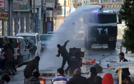 Riot police use a water cannon to disperse stone throwing Kurdish demonstrators during a protest against the curfew in Sur district, in the southeastern city of Diyarbakir, Turkey, December 22, 2015. REUTERS/Sertac Kayar