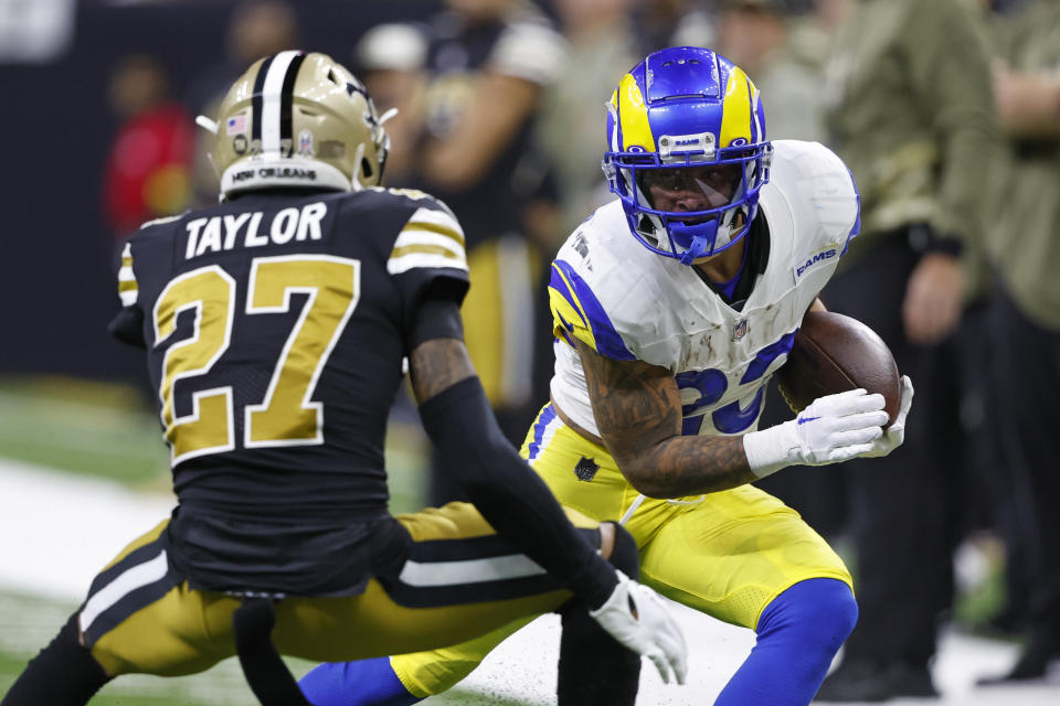 Los Angeles Rams running back Kyren Williams (23) tries to get past New Orleans Saints cornerback Alontae Taylor (27) in the first half of an NFL football game in New Orleans, Sunday, Nov. 20, 2022. (AP Photo/Butch Dill)