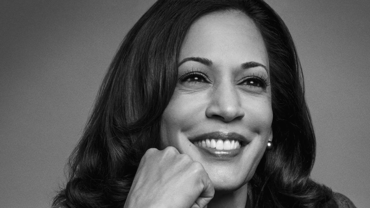 vice president kamala harris smiling with her hand on her chin