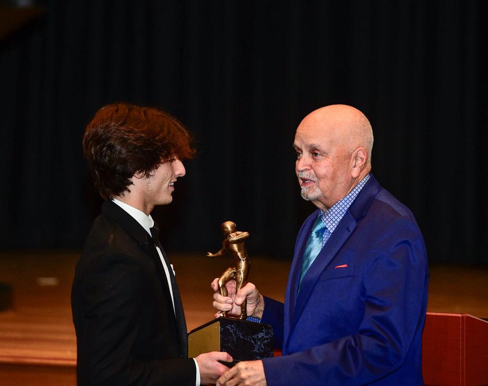 Richard Fabio presents the Otto Graham trophy to this years recipient Ty Kelley of Bourne High School during Wednesday's award ceremony.