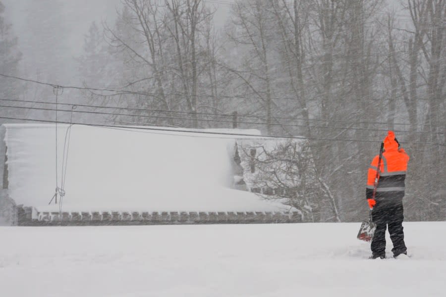 A person uses a shovel trying to clear snow from a property during a storm, Saturday, March 2, 2024, in Truckee, Calif. A powerful blizzard howled Saturday in the Sierra Nevada as the biggest storm of the season shut down a long stretch of Interstate 80 in California and gusty winds and heavy rain hit lower elevations, leaving tens of thousands of homes without power. (AP Photo/Brooke Hess-Homeier)