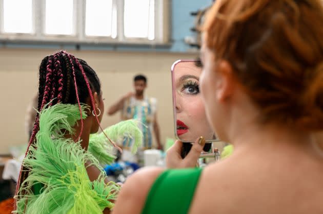 A dancer for the Paraiso School of Samba applies makeup ahead of this year's Carnival parade. (Photo: Clara Watt for HuffPost)