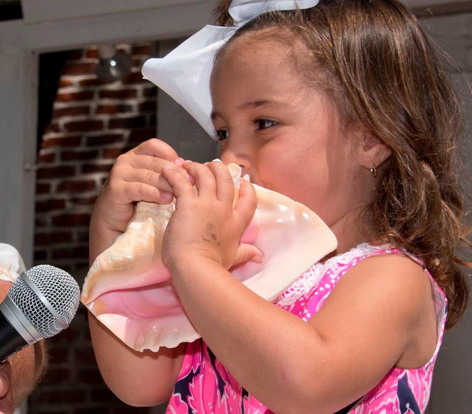 Cecelia Sheffer toots her conch shell during the Conch Shell Blowing Contest Saturday, March 4, 2017, in Key West, Fla. Three-year-old Sheffer of Key West was the youngest of dozens of entrants who were evaluated for the quality, duration, loudness and novelty of the sounds they produced. The fluted, pink-lined conch shell, a symbol of the Florida Keys, has been used as a signaling device in the islands for centuries. FOR EDITORIAL USE ONLY (Rob O’Neal/Florida Keys News Bureau/HO)