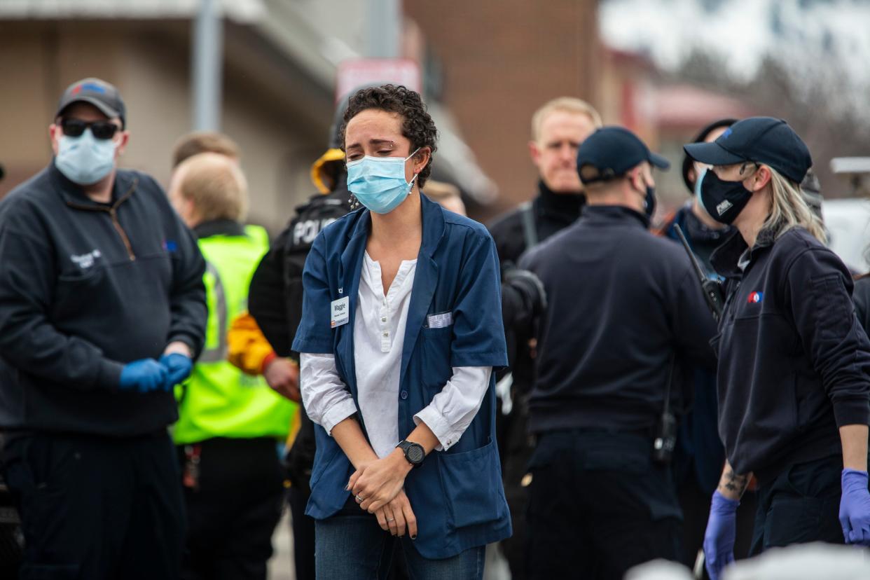 Healthcare workers walk out of a King Sooper's Grocery store after a gunman opened fire on March 22, 2021, in Boulder, Colorado.