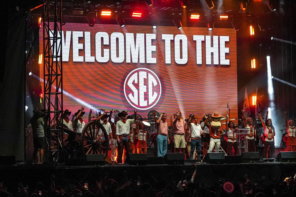 A welcome sign is displayed onstage during Sunday night's SEC Celebration on the UT campus. Texas, which co-founded the Big 12 in 1996, officially joined the SEC on Monday.