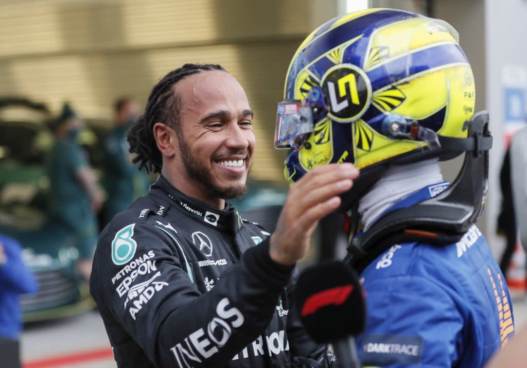 Lewis Hamilton is congratulated by Lando Norris (EPA)