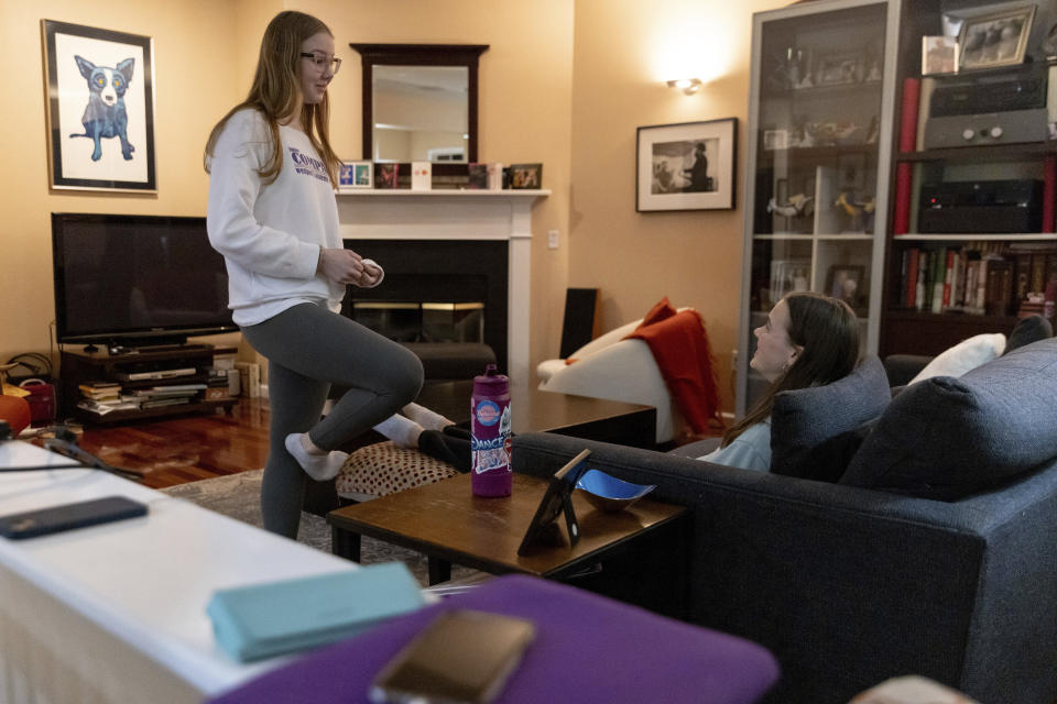 Kate and Sutton Bulkeley talk in the living room, Friday, Feb. 16, 2024, in Westport, Conn. No longer just a distraction or a way to connect with friends, social media has matured into a physical space and a community that almost all U.S. teenagers belong to. Up to 95% of teenagers say they use social media, with more than one-third saying they are on it “almost constantly,” according to the Pew Research Center. (AP Photo/Julia Nikhinson)