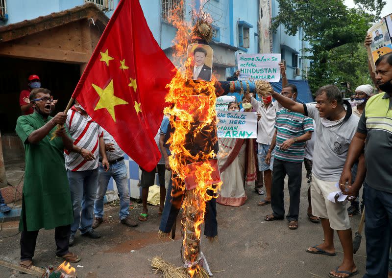 FILE PHOTO: Demonstrators shout slogans as they burn an effigy depicting Chinese President Xi Jinping during a protest against China, in Kolkata