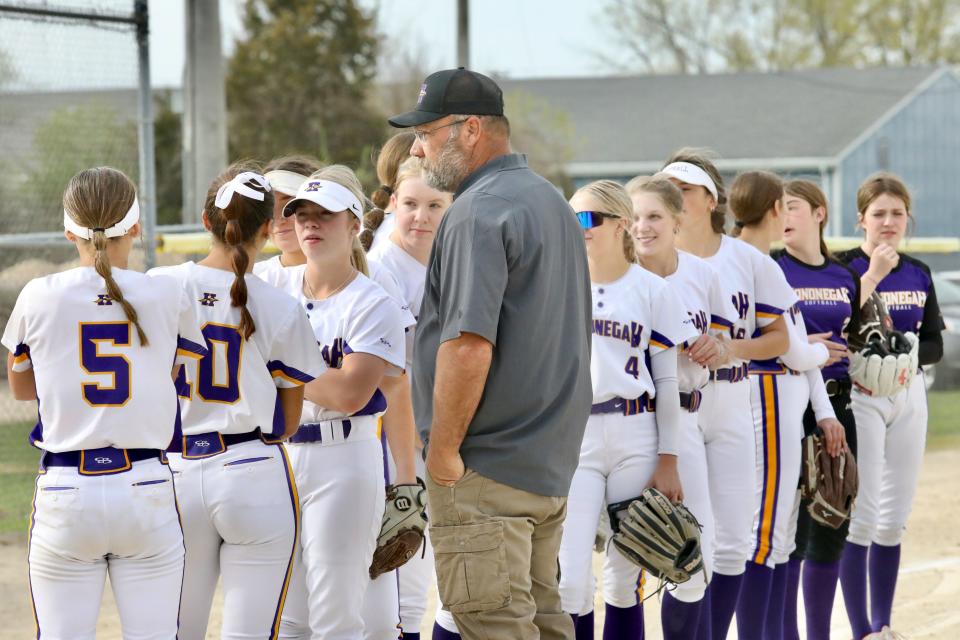 Hononegah softball coach Dennis McKinney talks with his team Monday, April 22, 2024, prior to a NIC-10 softball game against Belvidere North at Swanson Park in Roscoe.