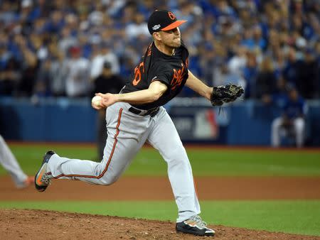 Baltimore Orioles relief pitcher Darren O'Day (56) pitches during the tenth inning against the Toronto Blue Jays in the American League wild card playoff baseball game at Rogers Centre. Mandatory Credit: Dan Hamilton-USA TODAY Sports