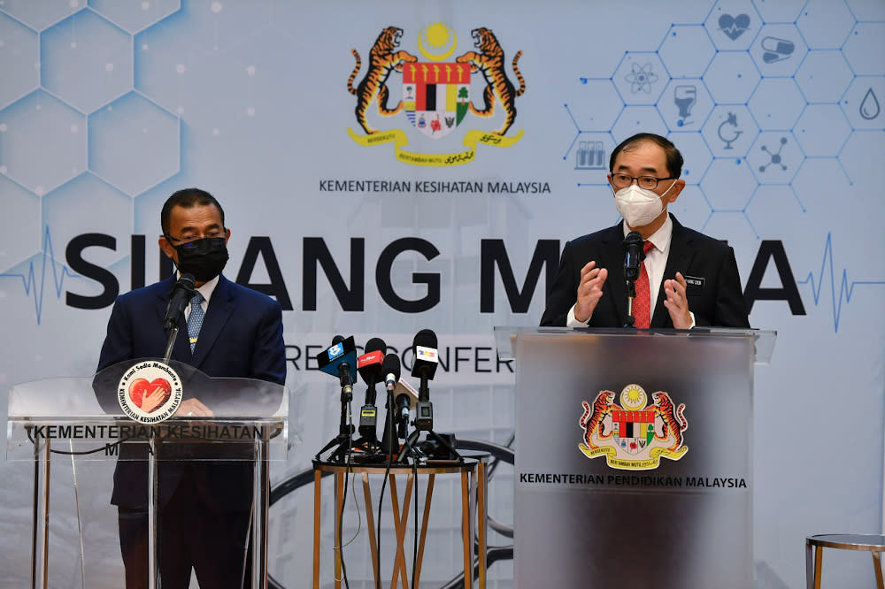 Deputy Education Minister Datuk Mah Hang Soon (right) speaks during a joint press conference with Deputy Health Minister Datuk Dr Noor Azmi Ghazali (left) in Putrajaya September 22, 2021. — Bernama pic