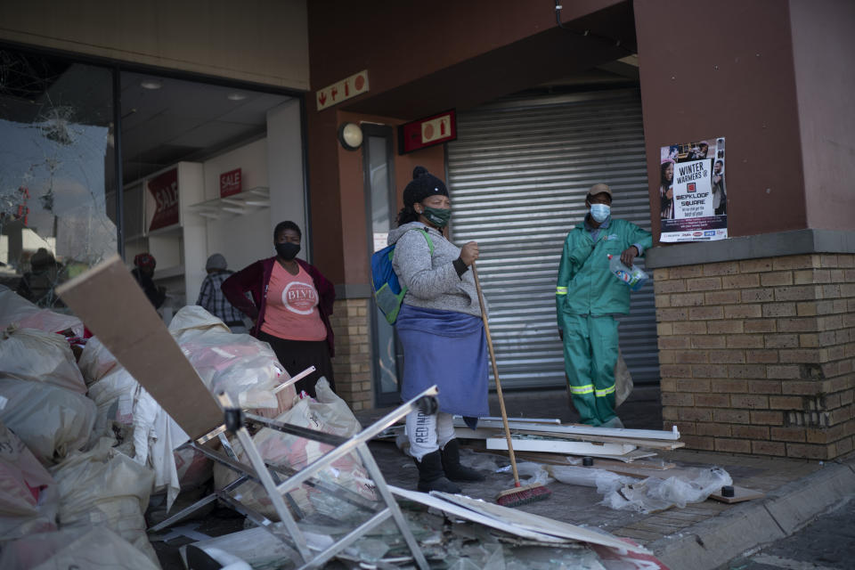 Volunteers participate in the cleaning efforts at Soweto's Diepkloof mall outside Johannesburg, South Africa, Thursday July 15, 2021. A massive cleaning effort has started following days of violence in Gauteng and KwaZulu-Natal provinces. (AP Photo/Jerome Delay)