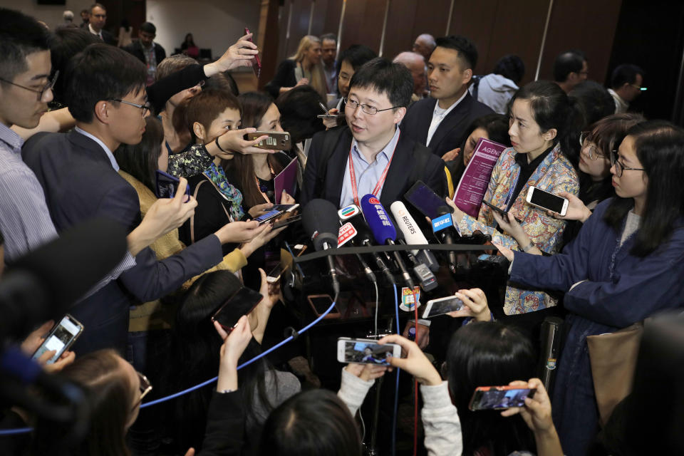 Feng Zhang, center, an institute member of Harvard and MIT's Broad Institute, is surrounded by reporters while speaking on the issue of world's first genetically edited babies after the Human Genome Editing Conference in Hong Kong, Tuesday, Nov. 27, 2018. He Jiankui, a Chinese researcher, claims that he helped make the world's first genetically edited babies twin girls whose DNA he said he altered with a powerful new tool capable of rewriting the very blueprint of life. If true, it would be a profound leap of science and ethics. (AP Photo/Vincent Yu)