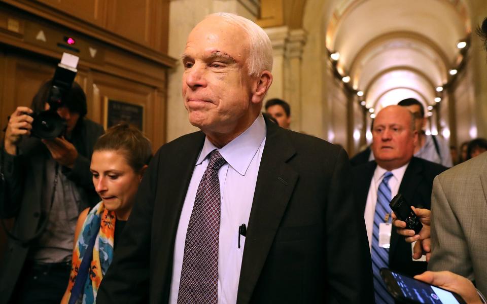 John McCain leaves the Senate chamber after voting against the "skinny" repeal bill - Credit: Getty images