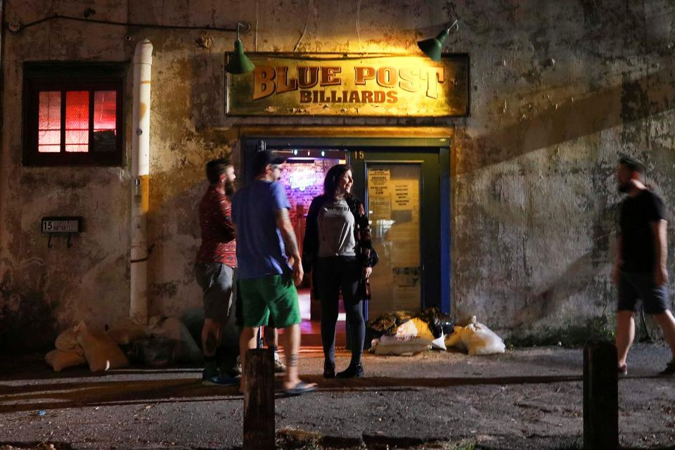 Customers gather outside Blue Post Billiards in 2018 in downtown Wilmington.