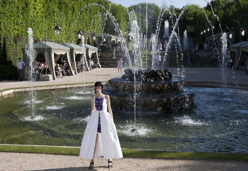 A model presents a creation by German fashion designer Karl lagerfeld for Chanel Monday, May, 14, 2012. Master of Fashion, Karl Lagerfeld spares no expenses for his midseason Chanel Cruise show offering held at the former home of Marie Antoinette, the Chateau de Versailles, southwest of Paris. (AP Photo/Jacques Brinon)