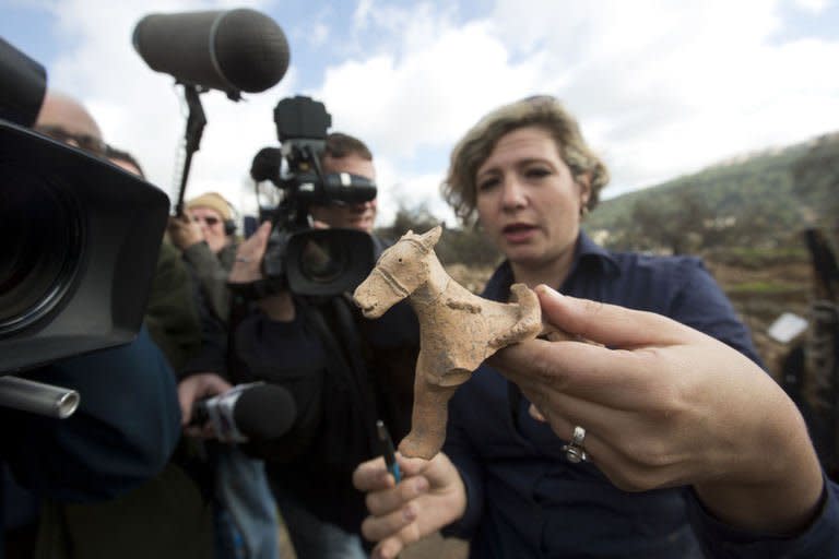 Israel Antiquities Authority archeologist Anna Ririkh displays on December 26, 2012 a clay figurine used for religious rituals and practices, dated to the early monarchic period (9-10th century. BC) of the Judaean monarchy, uncovered in Tel Motza near Jerusalem during rescue excavations