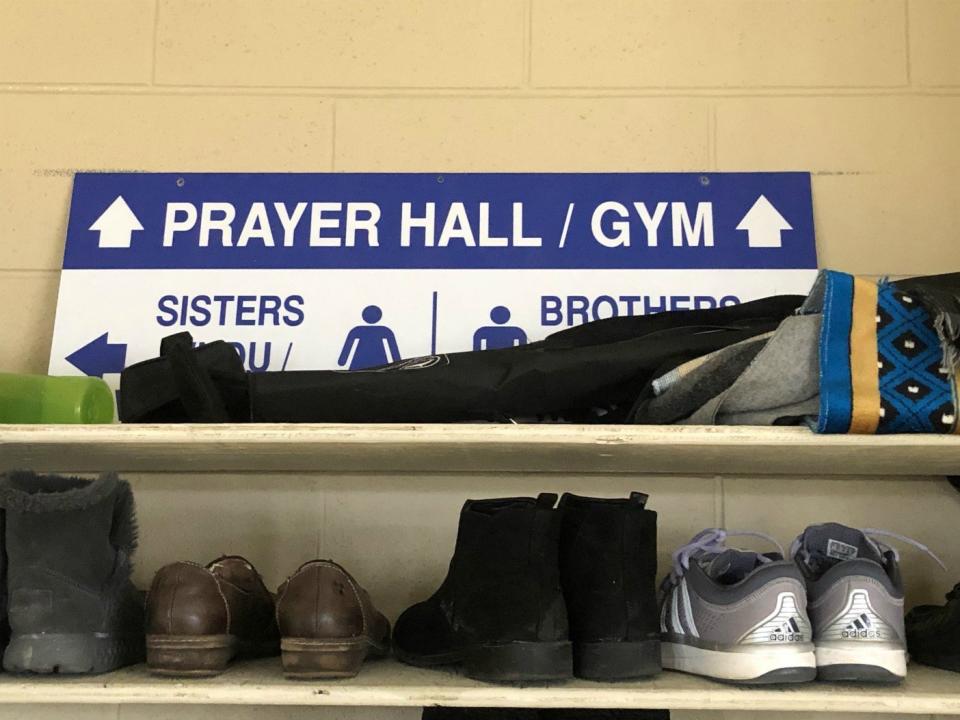 A sign directs worshipers to the entrance of the mosque at the Islamic Institute of Toronto. 